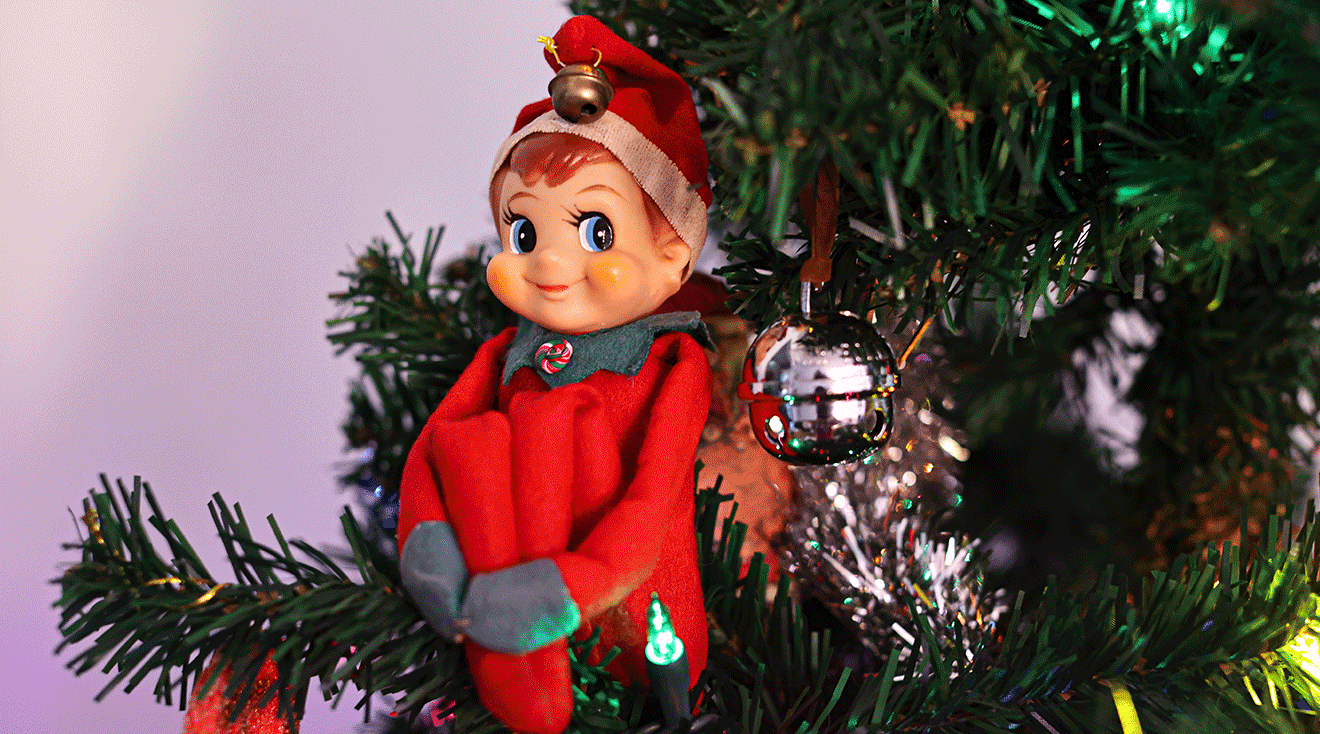 elf sitting in christmas tree