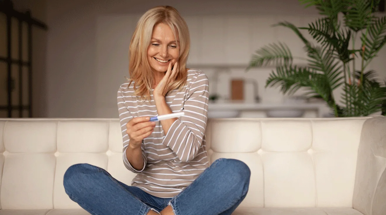 woman in her 40s with positive pregnancy test