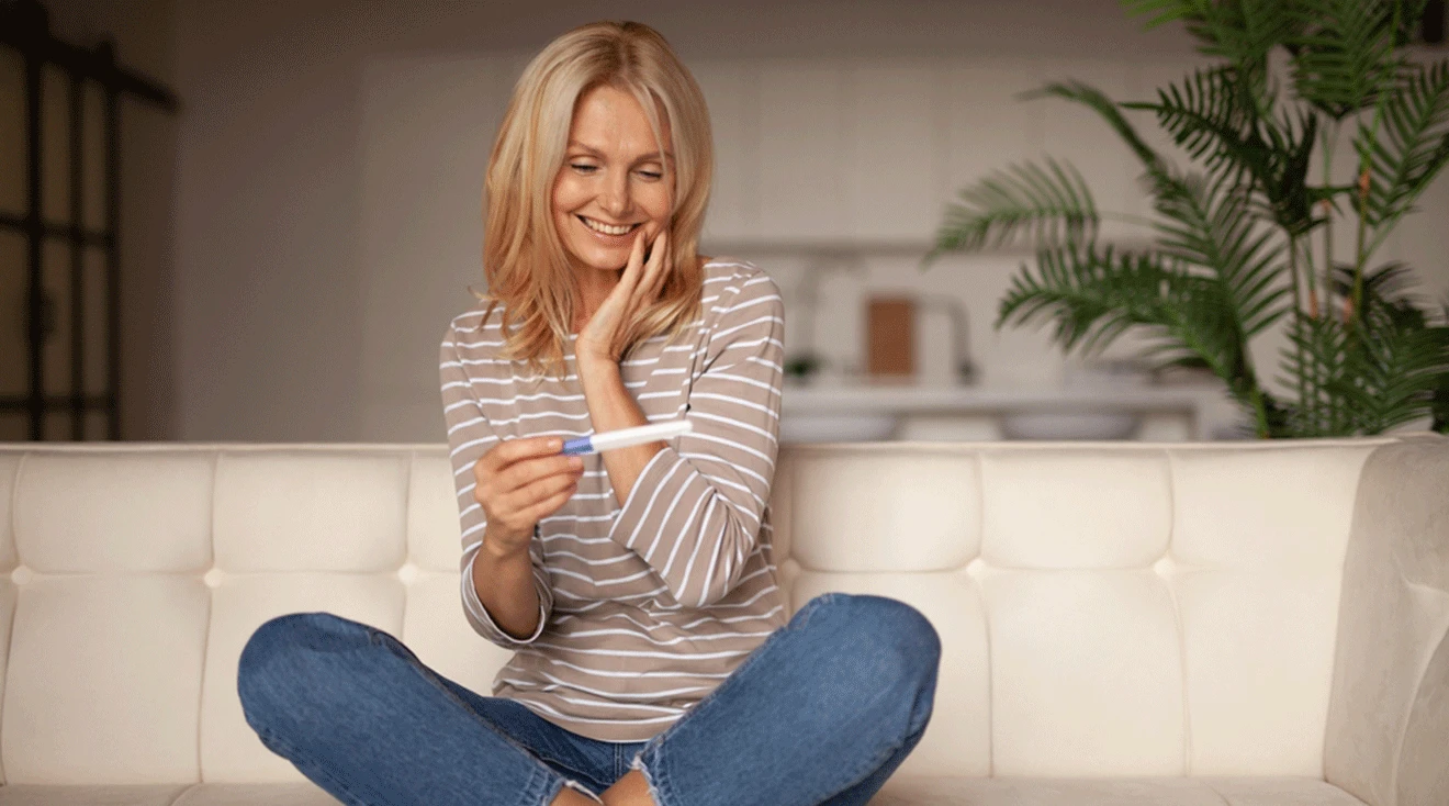 woman in her 40s with positive pregnancy test