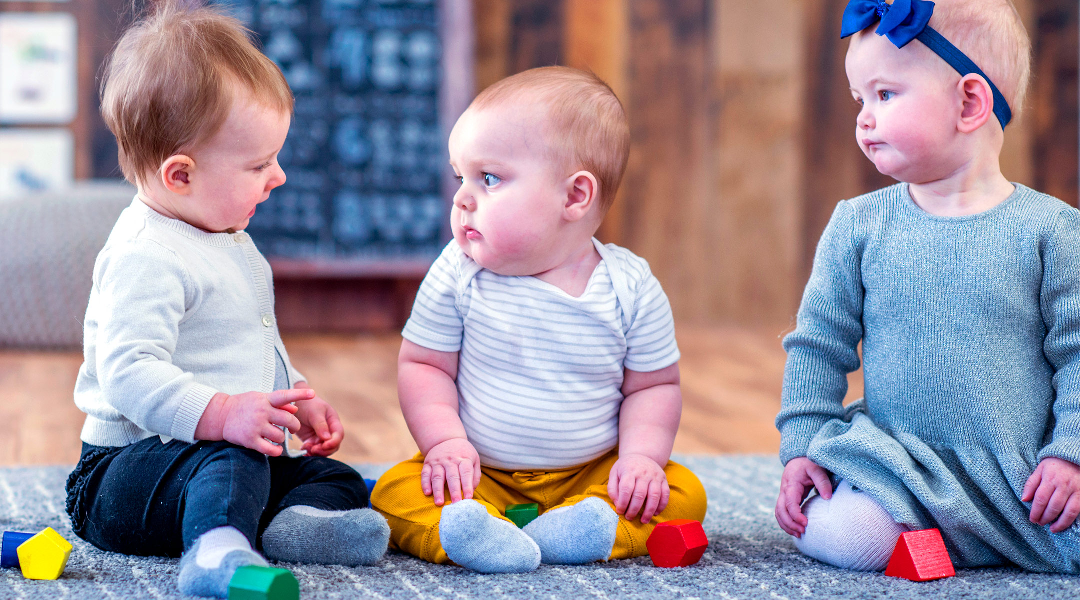 group of babies sitting, looking bored