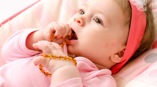 Amber teething necklace on baby