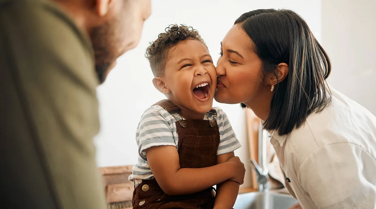 family laughing in the kitchen