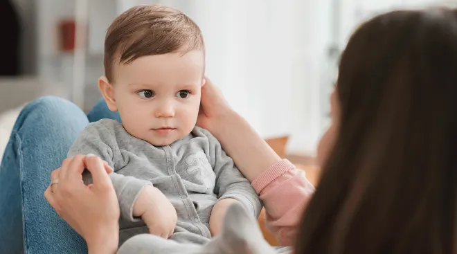 baby looking at mom talking