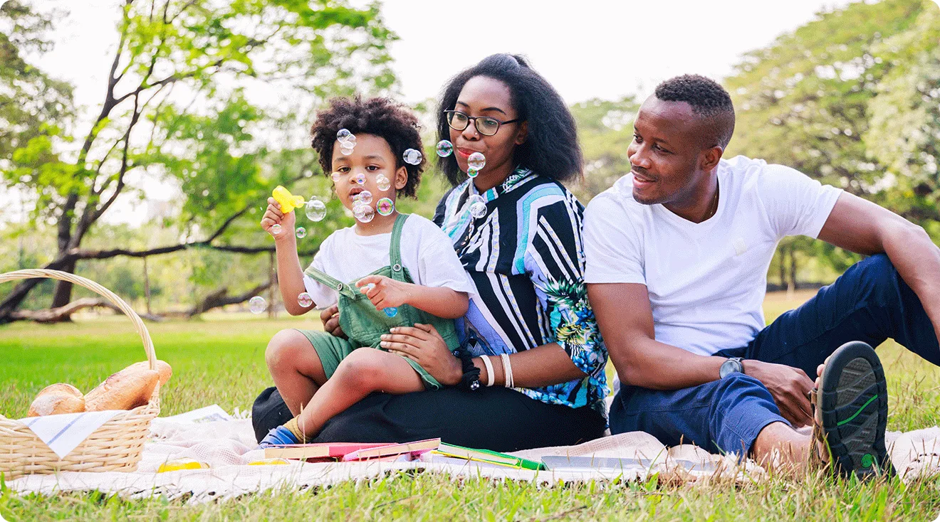parents having a picnic with child on a summer day in the park