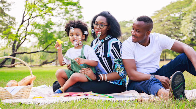 parents having a picnic with child on a summer day in the park