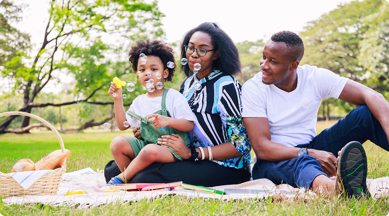 parents having a picnic with child on a summer day in the park