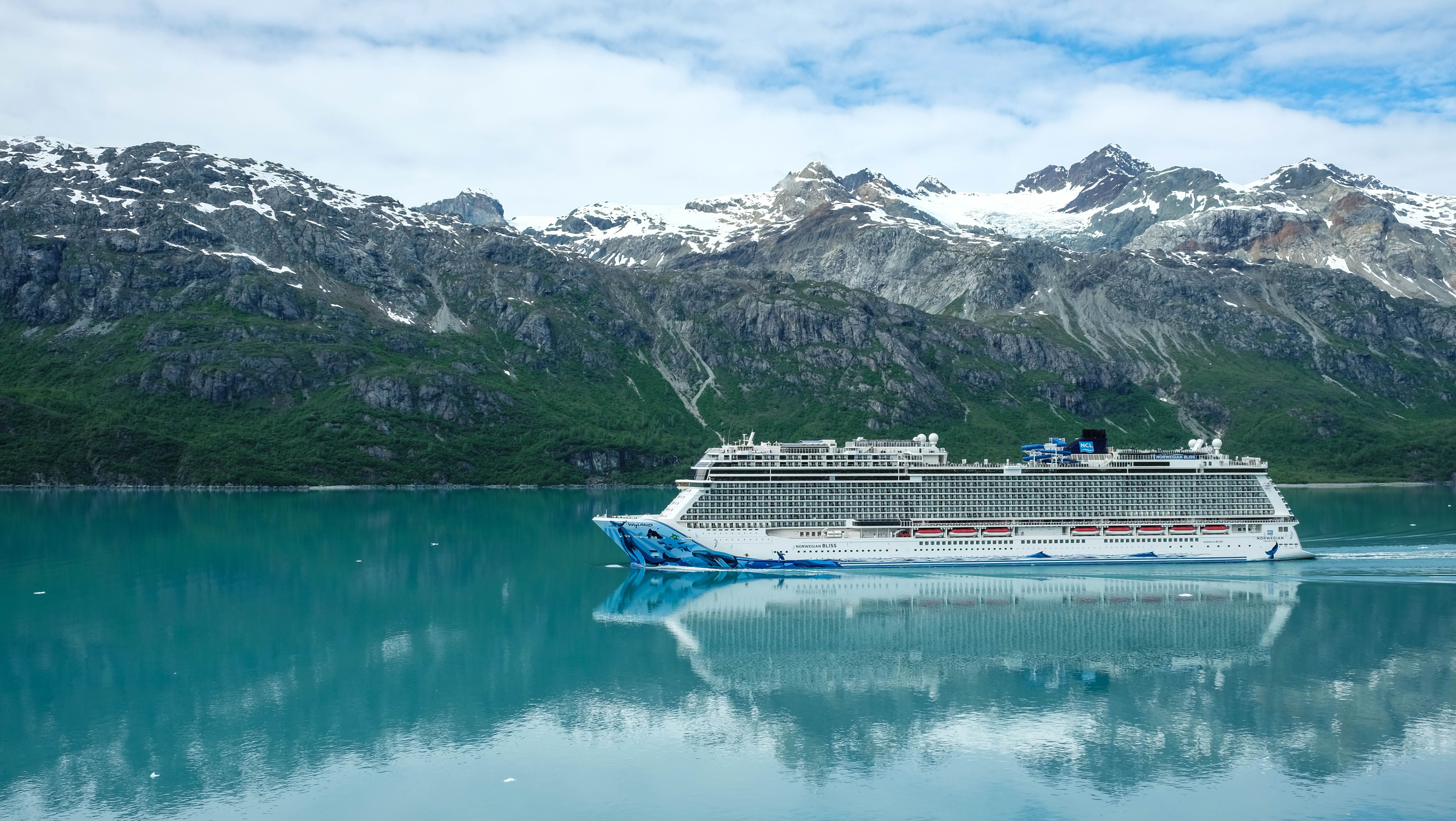 An Alaskan fjord at dusk, seen from the deck of a ship