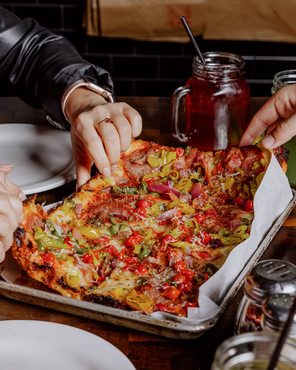 People sharing a pizza