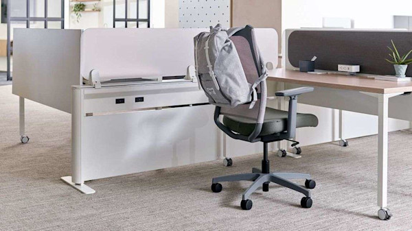Chair at desktop for one in hybrid office.