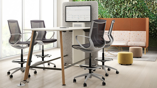 flexible office space with employee meeting area and acoustic furniture