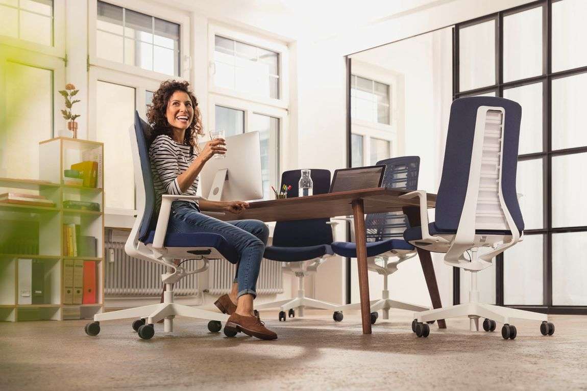 woman sitting on a comfortable office chairin a brightly lit conference room