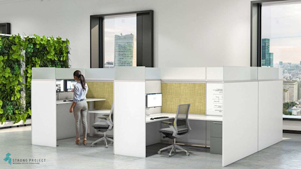 Woman standing at white privacy cubicle