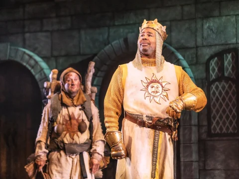 Production shot of Spamalot in New York, with Christopher Fitzgerald as Patsy and James Monroe Iglehart as King Arthur.