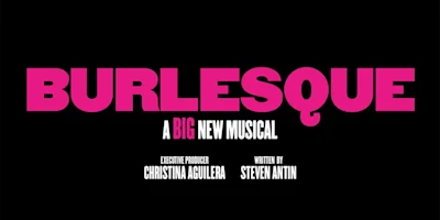 Black background with bold pink text reading "BURLESQUE," and white text below stating "A Big New Musical," plus credits for Christina Aguilera and Steven Antin.