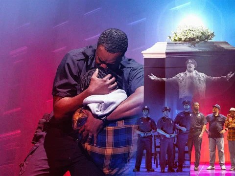 Production photo of Blue in Chicago, showing a stage scene shows a man in uniform comforting another person, while in the background, officers and performers stand near a podium with flowers, highlighted by dramatic lighting.