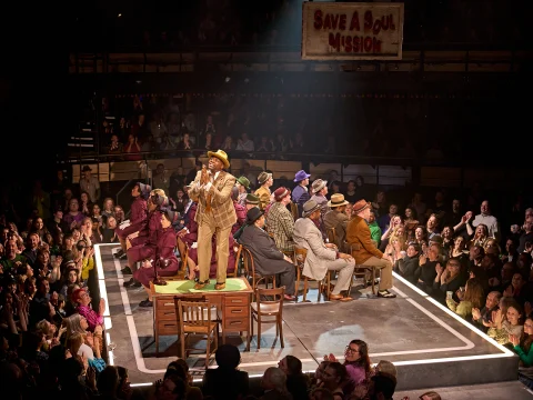 Production shot of Guys & Dolls in London, with Cedric Neal as Nicely-Nicely Johnson.
