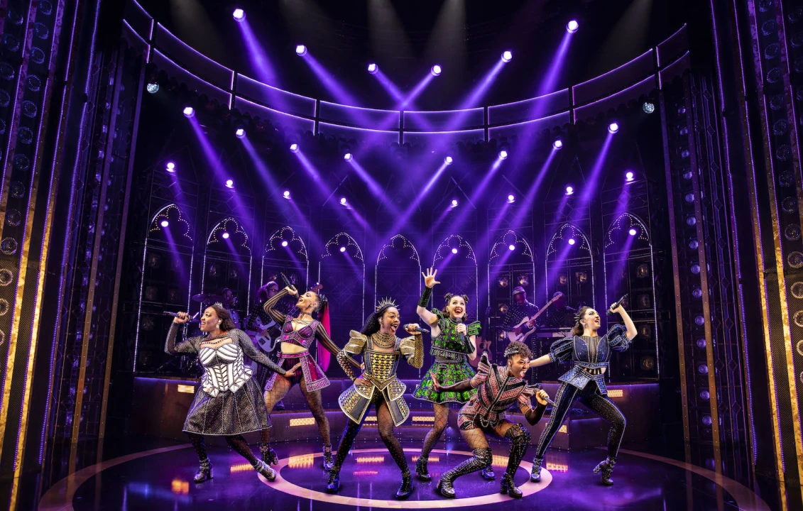 Production shot of SIX in London, showing main cast singing.