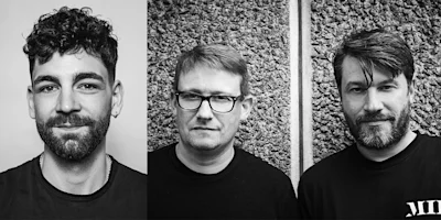 Three men with facial hair pose for black-and-white portraits; the first has curly hair, the second wears glasses, and the third has straight hair and a beard.