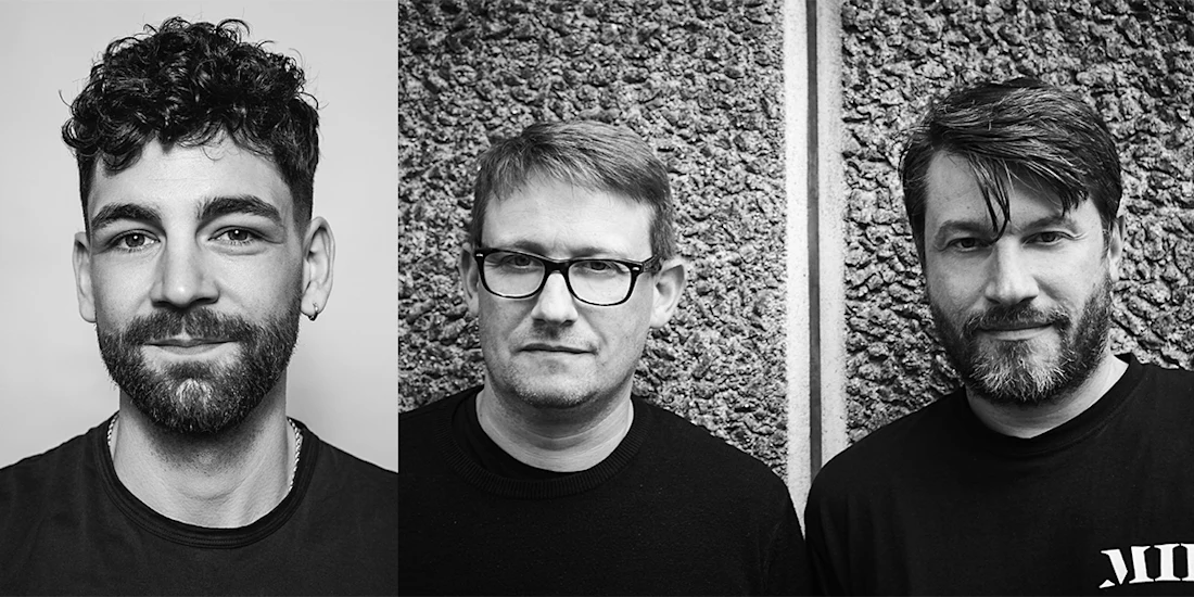 Three men with facial hair pose for black-and-white portraits; the first has curly hair, the second wears glasses, and the third has straight hair and a beard.
