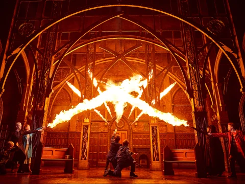 Production shot of Harry Potter and the Cursed Child in New York, showing fire and magic wands.