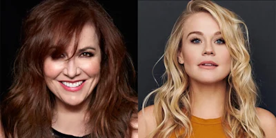 Two women with long hair facing the camera; the woman on the left has brown hair and is smiling, while the woman on the right has blonde hair and a neutral expression.