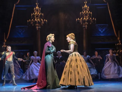 Production shot of Frozen the Musical in London, showing a royal event.