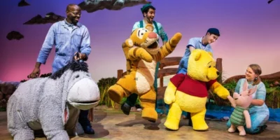 Photo credit: Emmanuel Elpenord as Eeyore, Chris Palmieri as Tigger, Jake Bazel as Pooh, and Kirsty Moon as Piglet in Winnie the Pooh. (Photo by Evan Zimmerman)