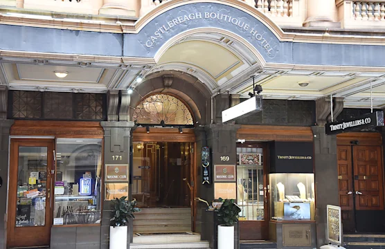 Entrance to Castlereagh Boutique Hotel with arched doorway and shops on either side, including a jewelry store named Tinity Jewellers Co.
