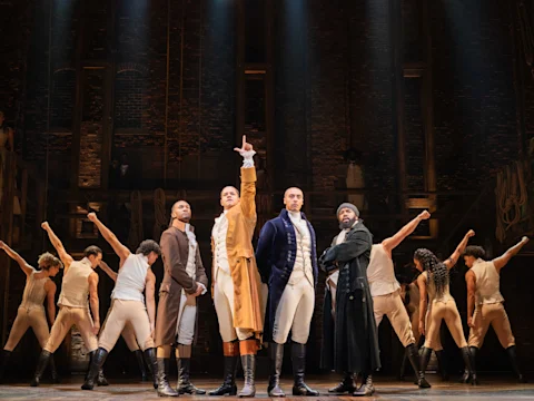 Production shot of Hamilton in London, with Shan Ako as Eliza Hamilton, Allyson Ava Brown as Angelica Schuyler and Roshani Abbey as Peggy Schuyler.