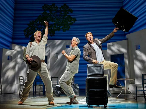 Production shot of Mamma Mia! in DC showing an ensemble celebration.