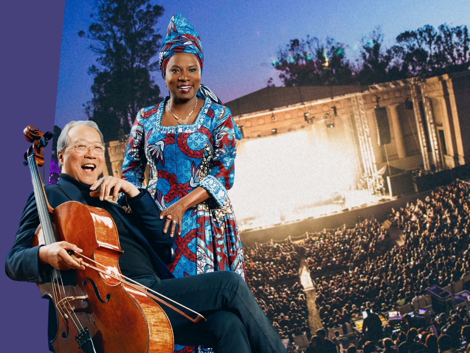 A man holding a cello sits next to a woman in a colorful outfit and headwrap, with an outdoor concert venue and large audience in the background.