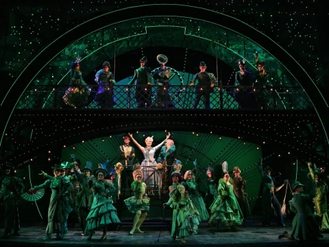 Production shot of Wicked in New York, showing an ensemble performing.
