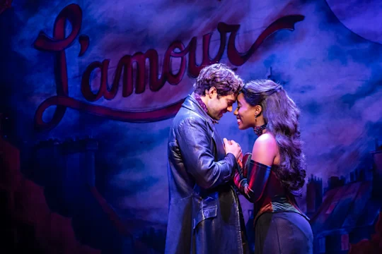 Production shot of Moulin Rouge! The Musical in London, with Dom Simpson as Christian and Tanisha Spring as Satine.