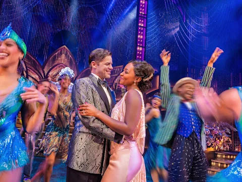 Production shot of The Great Gatsby on Broadway, with Jeremy Jordan and Aisha Jackson.