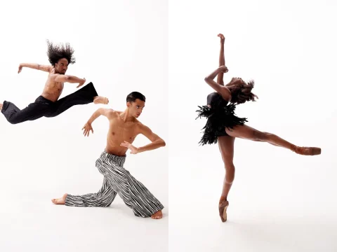 Two dancers perform: the dancer on the left leaps mid-air wearing black pants, and the dancer on the right in a black outfit balances on pointe with one leg extended.