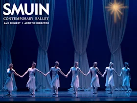 Seven ballet dancers in white costumes stand on stage holding hands in front of flowing white curtains under a star-like light. Text on the image reads "SMUIN Contemporary Ballet, Amy Seiwert / Artistic Director.