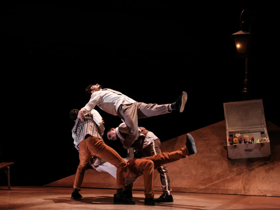 Production shot of Under the Weight of Feathers in New York City in a bold dance motion.