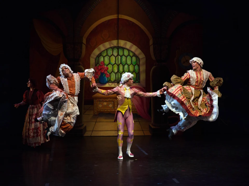 Production shot of NYTB presents Donald Mahler's Cinderella in NYC showing an ensemble celebration.