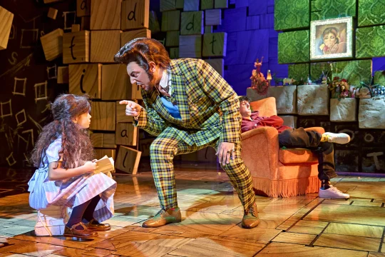 Production shot of Matilda The Musical in London, with Rakesh Boury as Mr. Wormwood.