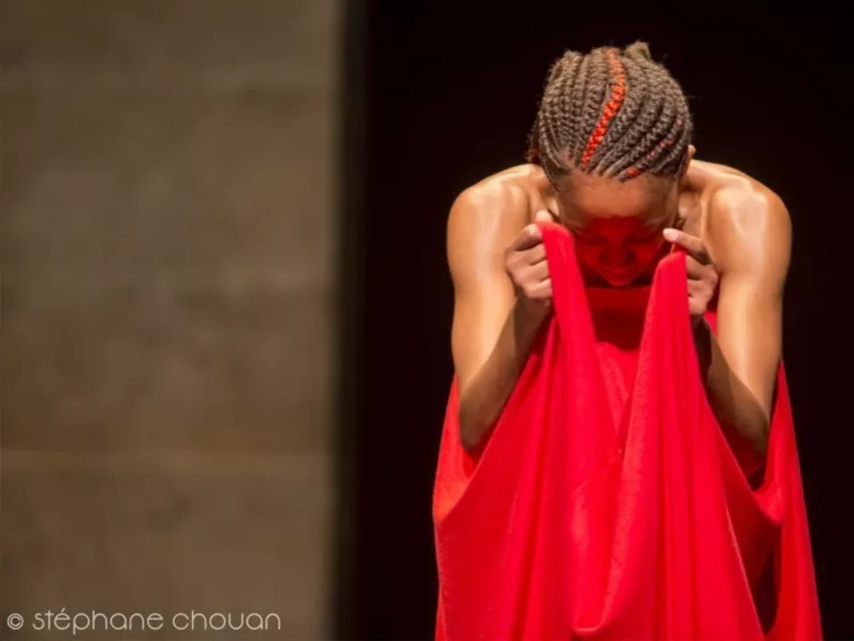 Production shot of Red Clay Dance La Femme Dance Festival in Chicago with Kenyan choreographer and dancer Wanjiru Kamuyu – WKcollective in her solo work Portraits in Red .