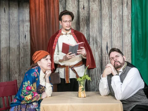 Production photo of Neil Simon's Fools in California with Miles Garcia as School Master Leon is asked to read the confounding tale of the Curse of Kulyenchikov to the Zubritskys, Alison Boole and Jon Sparks.