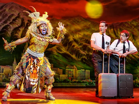 Production shot of The Book of Mormon in London featuring the 'Mormons' ensemble.