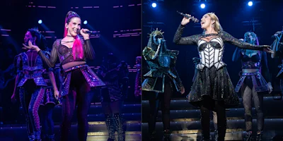 Two stage performers sing under blue and purple lighting, each flanked by backup singers in stylized costumes inspired by historical fashion.