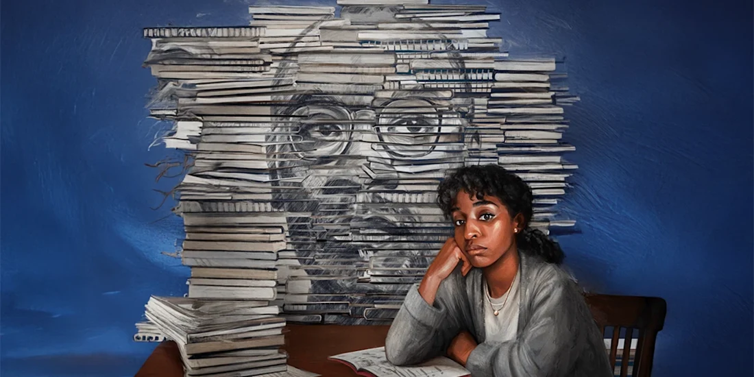 A woman sits at a desk with an open notebook, looking thoughtful, in front of a large stack of books arranged to depict a face on a blue background.