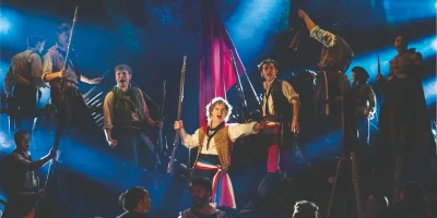Photo credit: Ashley Gilmour as Enjolras, Harry Apps as Marius and Company in Les Misérables (Photo by Johan Persson)