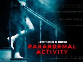 A person in nightwear descends a dimly lit staircase, surrounded by blue haze, with the text "Paranormal Activity: A New Story Live on Broadway" in bold red and white.