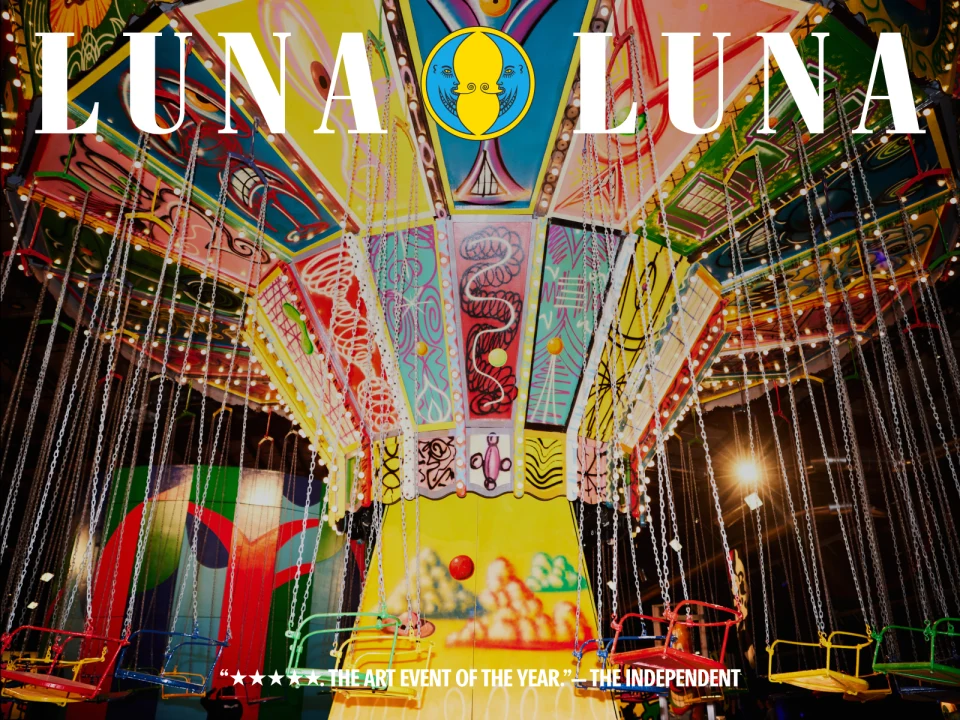 Colorful carnival ride with empty swings under vibrant lights. 