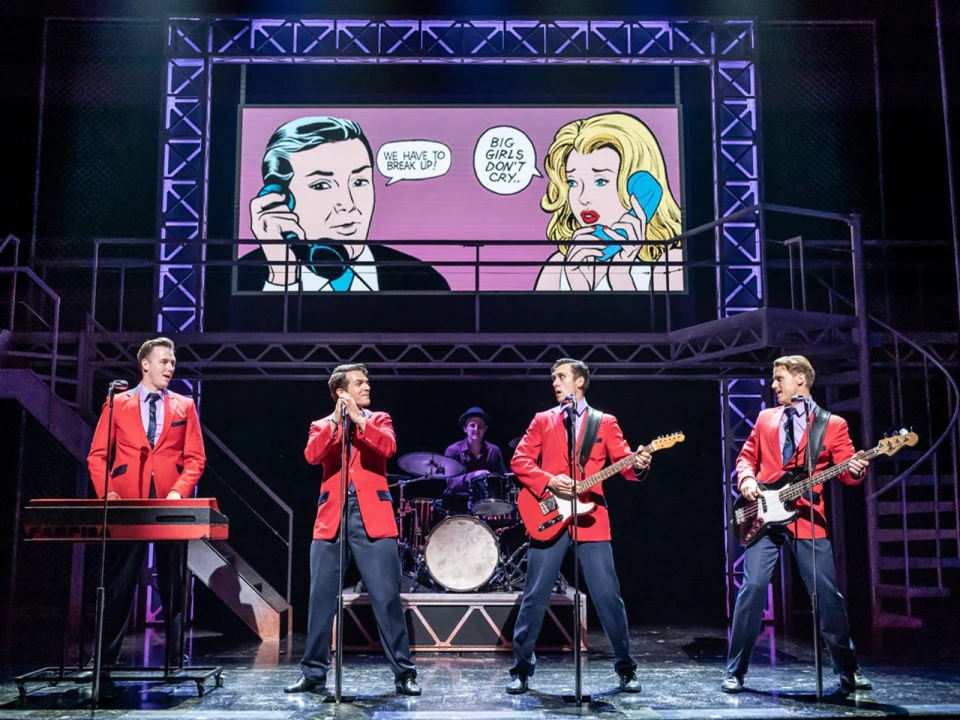 Production shot of Jersey Boys in London showing ensembles performing.