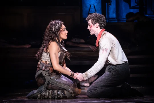 Production image of Hadestown in London, featuring Dónal Finn as Orpheus and Grace Hodgett Young as Eurydice.