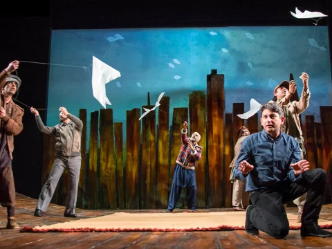 Production shot of The Kite Runner in New Jersey, showing ensemble flying kites.